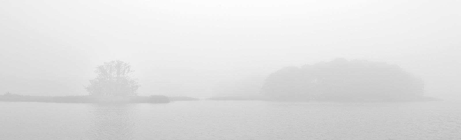 Foggy lake with small islands